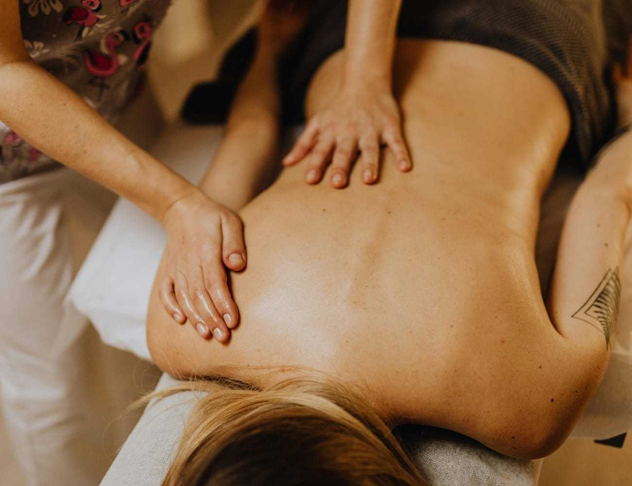Massage therapist giving a relaxing back massage.