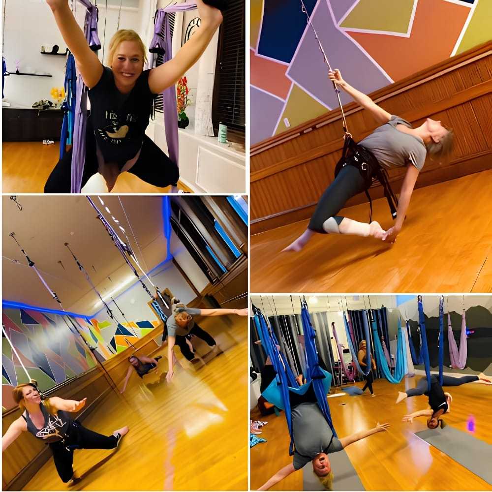 People engaging in aerial yoga using colorful hammocks in a studio.